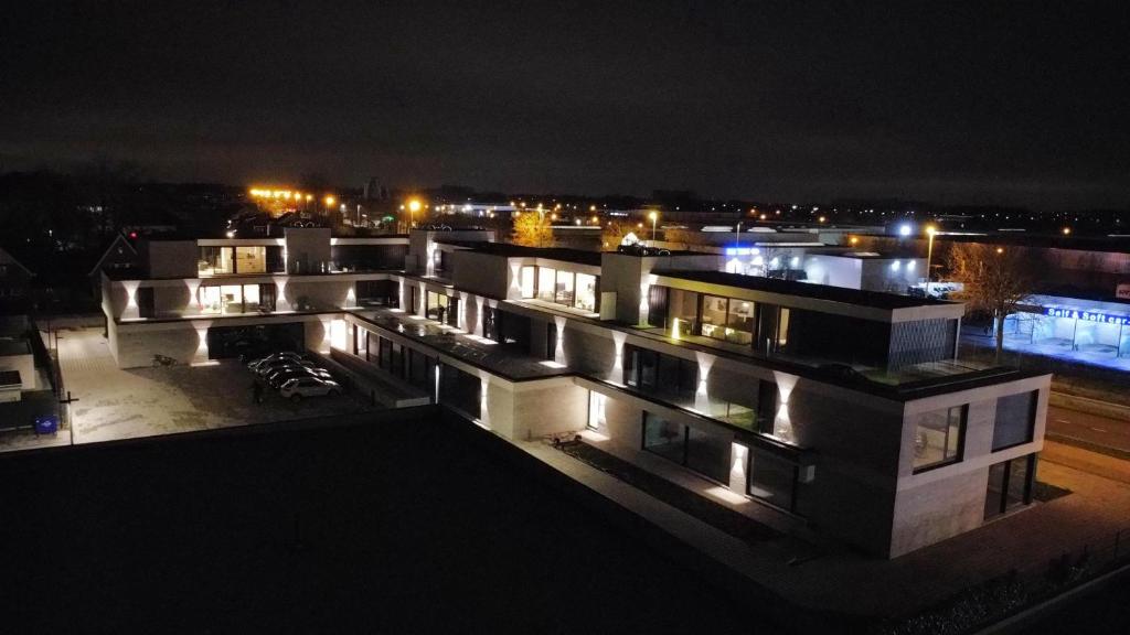 a view of a building at night with lights at ApartHotel Dénia in Lochristi