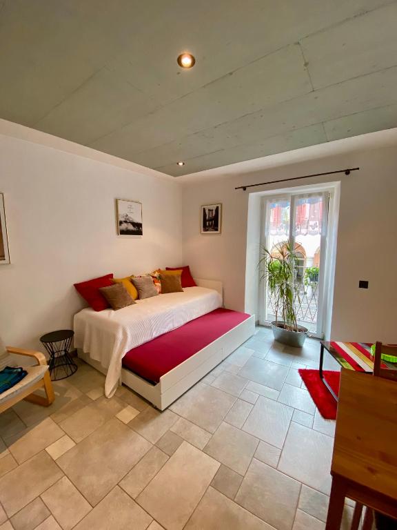 a bedroom with a bed and a large window at Cà dal Gascia in Intragna