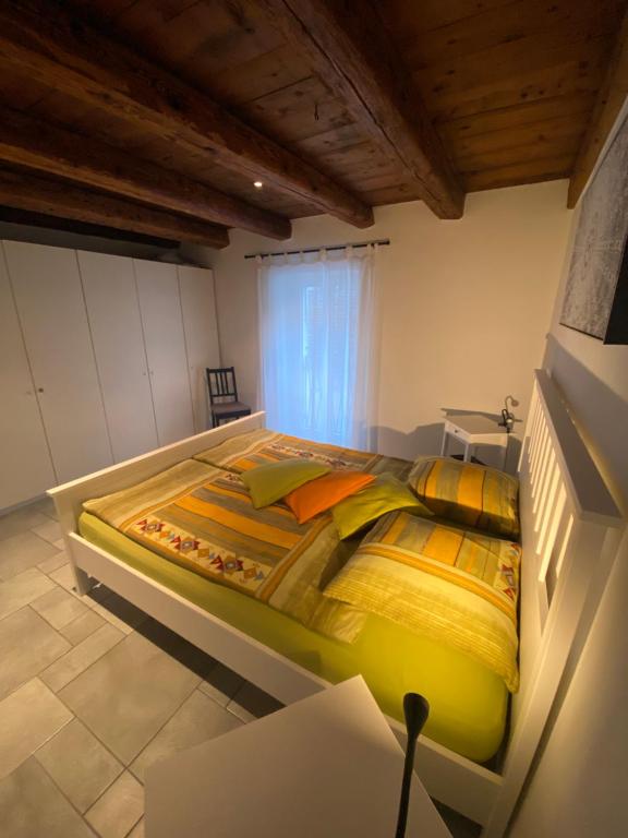 a bedroom with a large bed in a room at Cà dal Gascia in Intragna