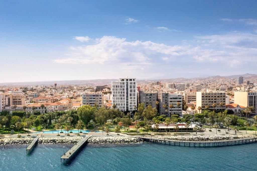 a city with a body of water and buildings at NYX Hotel Limassol in Limassol