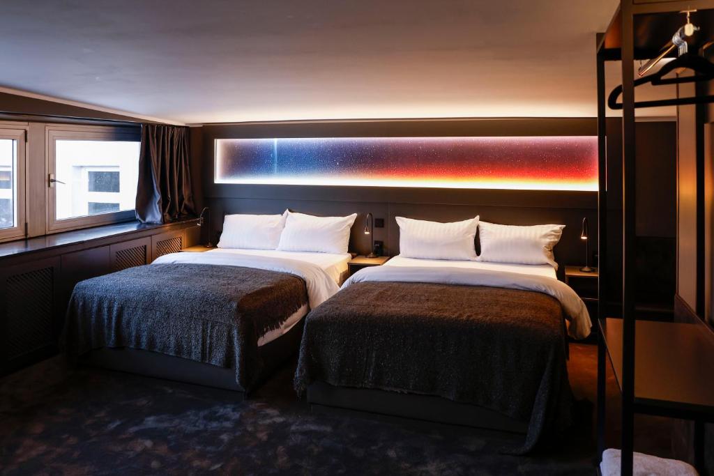Postel nebo postele na pokoji v ubytování Sleephotels Cosmos