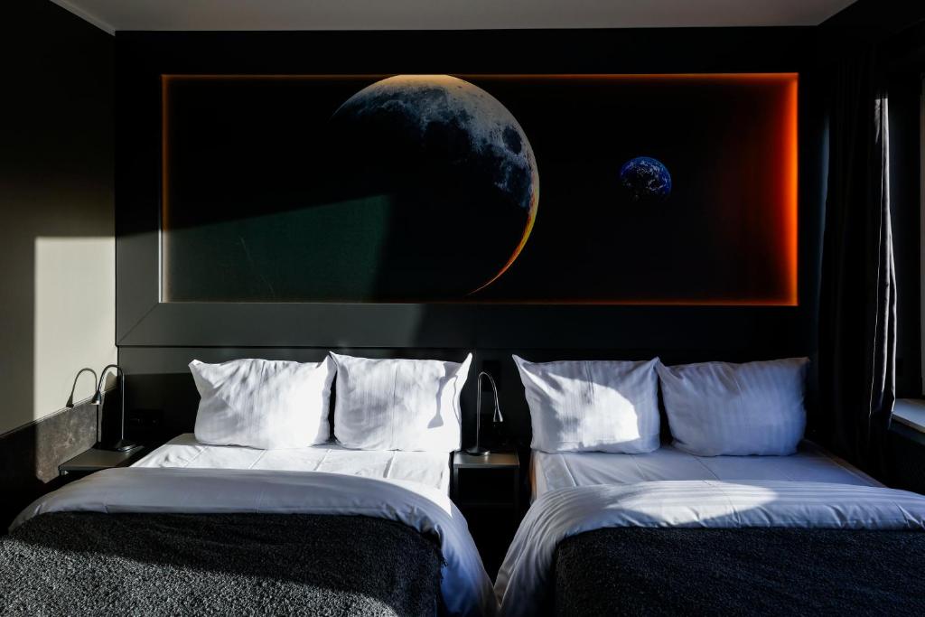 Postel nebo postele na pokoji v ubytování Sleephotels Cosmos
