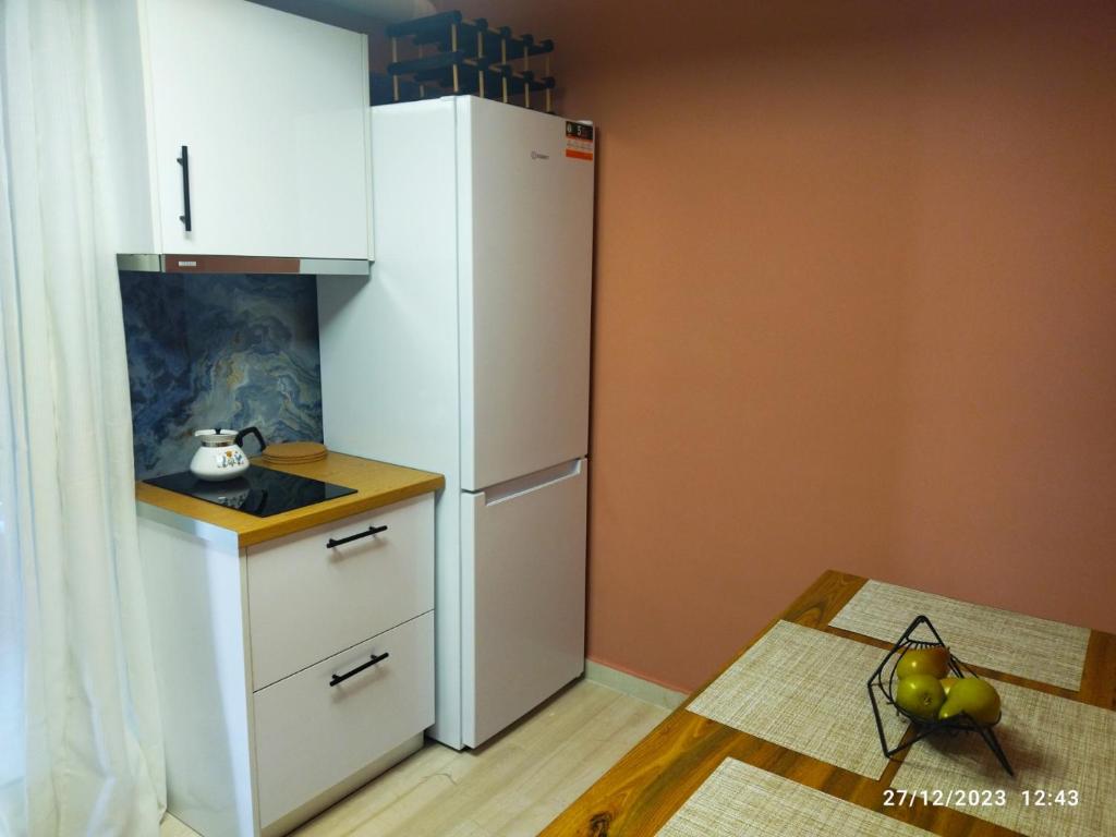 a kitchen with a white refrigerator in a room at Swan Paradise Glyfada Apartment in Athens