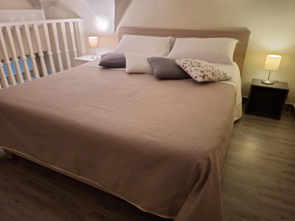 a bedroom with a large bed with two pillows on it at LA CASA DI NANA' in Naples
