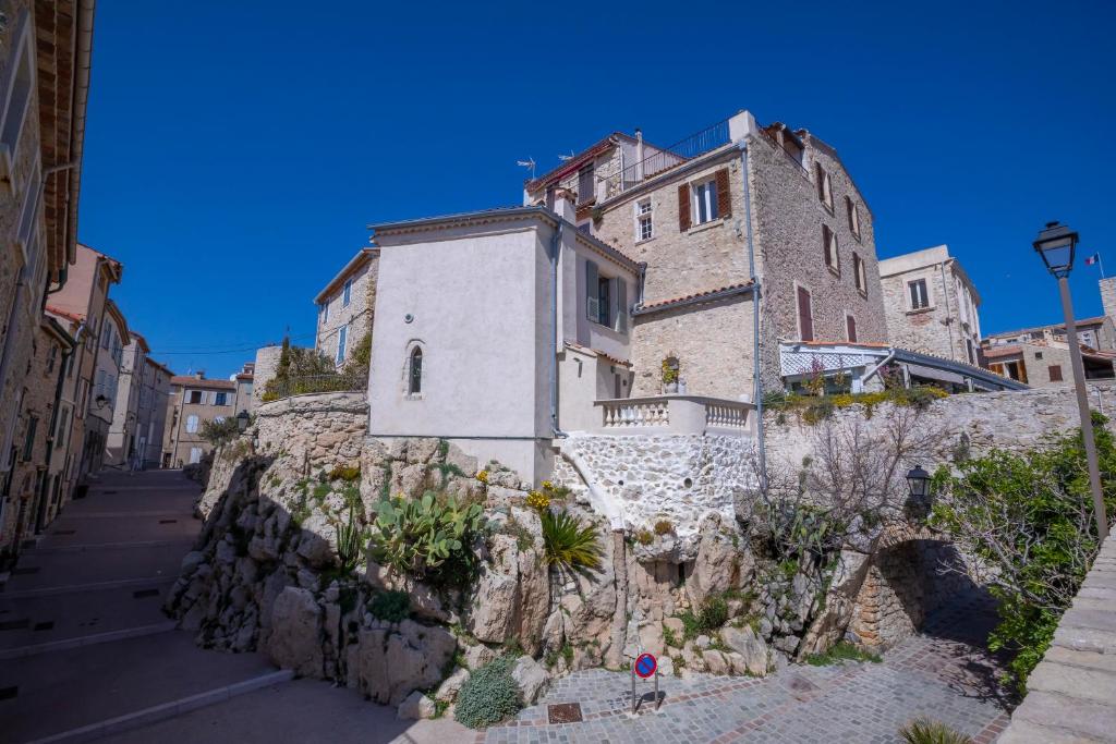 a building on the side of a stone wall at Apartment Matisse 100Mt Near The Sea - Happy Rentals in Antibes