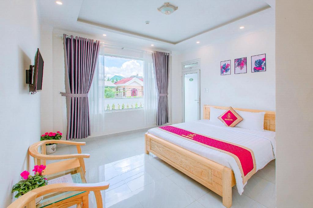 Schlafzimmer mit einem Bett und einem Fenster in der Unterkunft Ngọc Sang 3 Hotel in Da Thanh