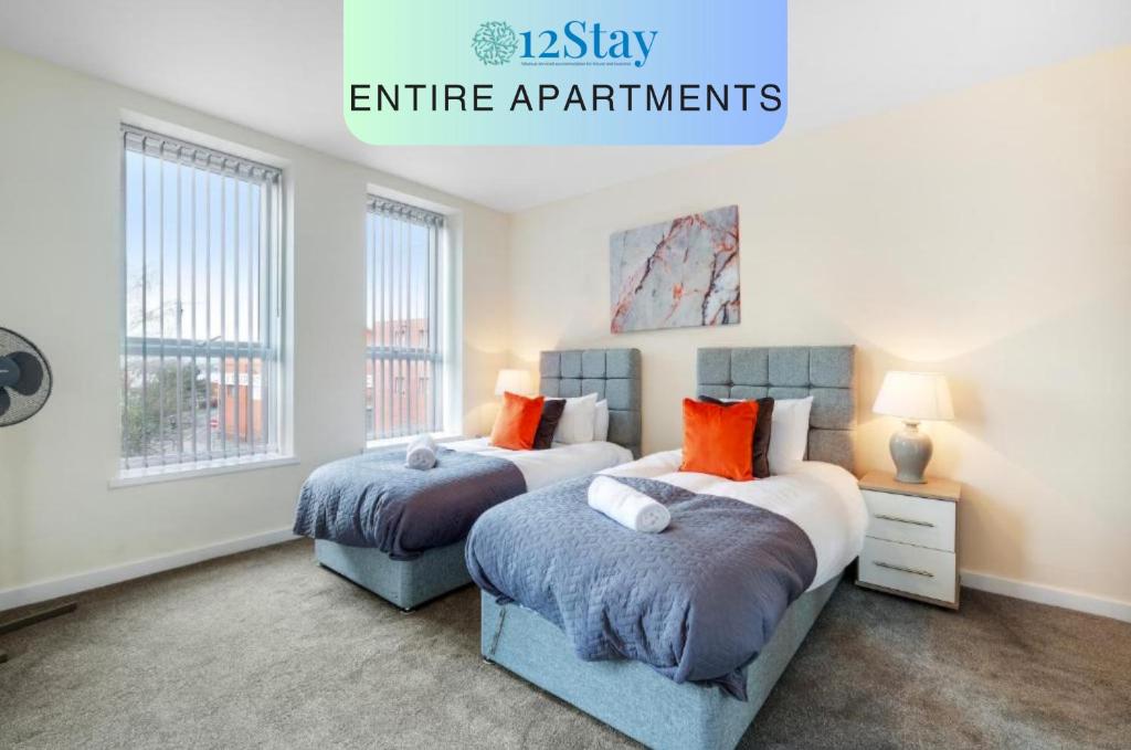 2 camas en un dormitorio con 2 ventanas en SPECIAL OFFER!! Wednesbury, 1& 2 Bedroom Apartments with Private Parking by 12Stay en Wednesbury