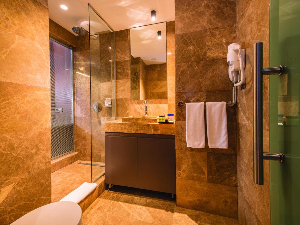 a bathroom with a toilet, sink, and shower stall at Blueway Hotel Historical in Istanbul