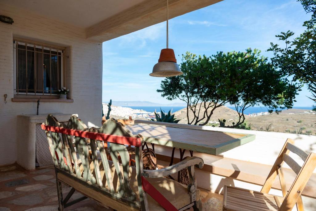 a table and a chair on a patio with a view at Eklekti House in Firókambos
