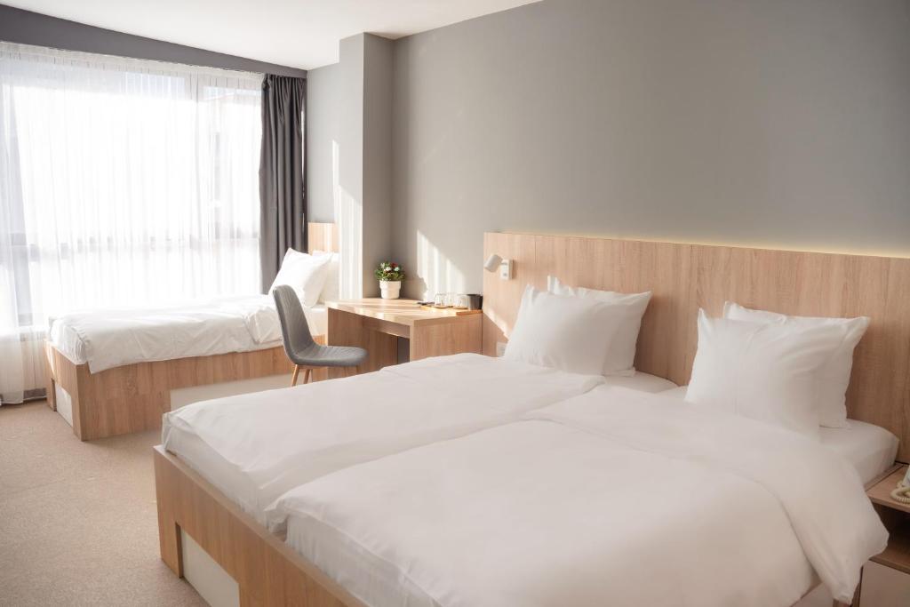 Postel nebo postele na pokoji v ubytování Olivia Rooms