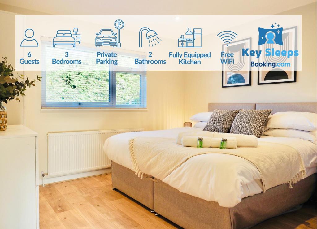 a bedroom with a bed with a poster on the wall at Luxurious Detached Bungalow with Private Parking in Farnborough