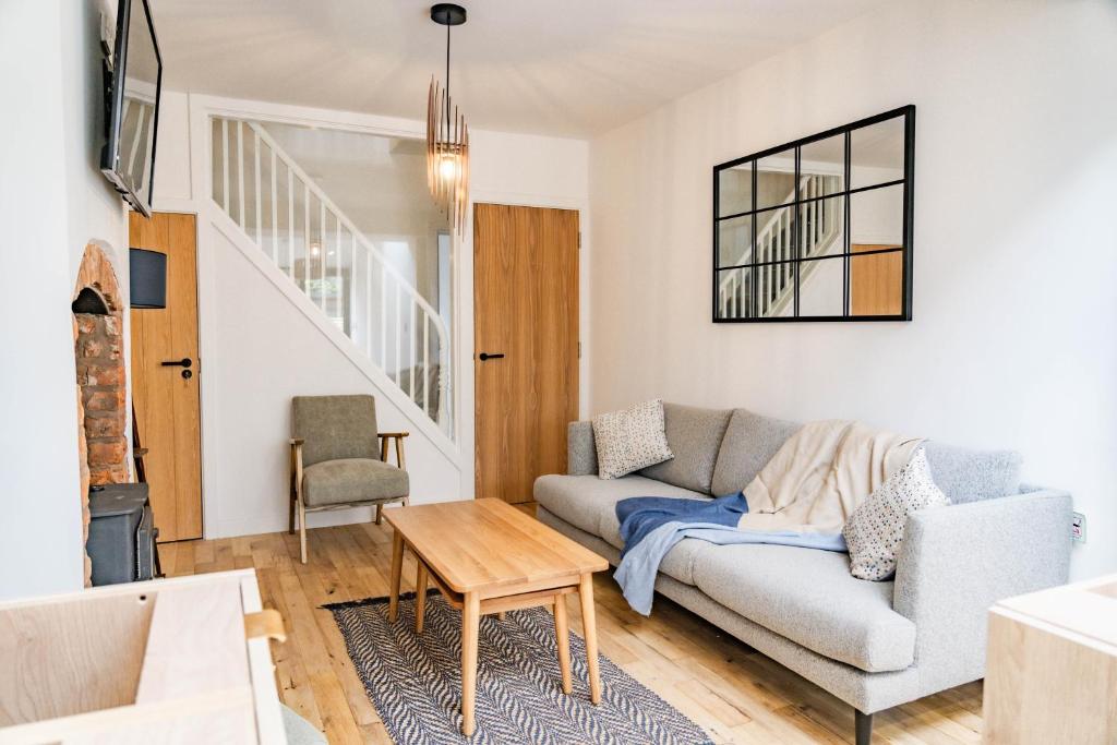 a living room with a couch and a table at Benyon Street Townhouse in Shrewsbury