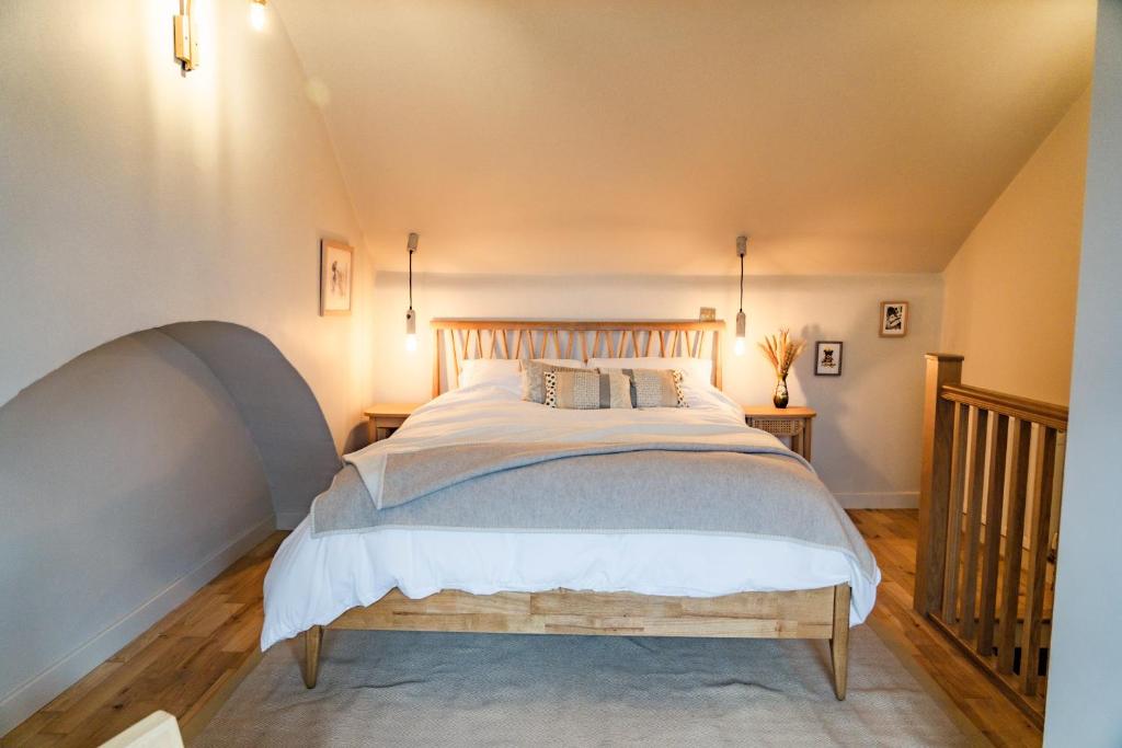 a bedroom with a large bed in a attic at Benyon Street Townhouse in Shrewsbury