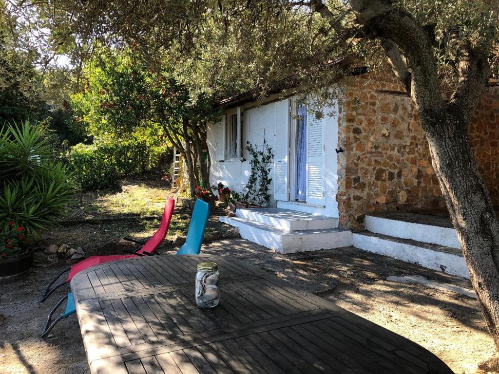 a cat sitting on a table in front of a house at Splendid cottage on Tuscan Sea in Porto Santo Stefano