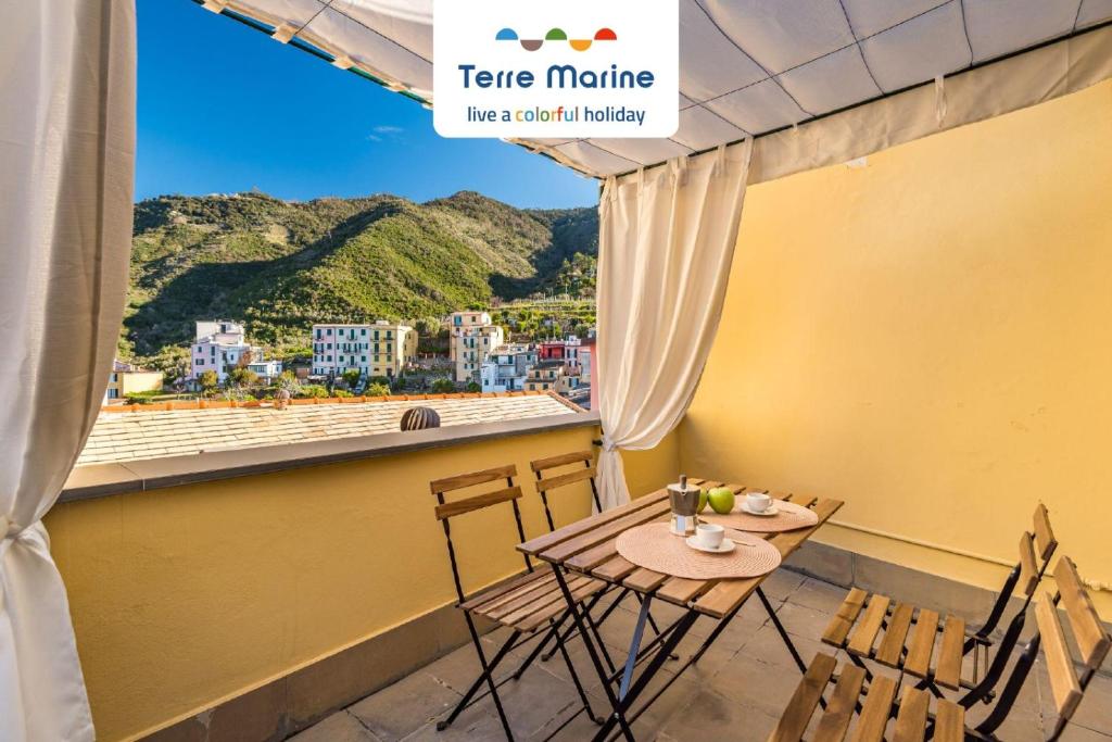 een tafel en stoelen op een balkon met uitzicht bij Il Borgo dei Ricordi, Terre Marine in Corniglia