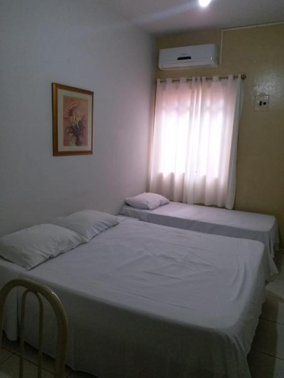 Postel nebo postele na pokoji v ubytování Hotel Confort Maringá