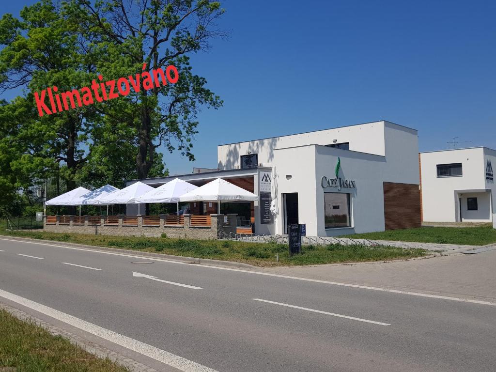 a building with a restaurant on the side of a road at Apartmány Miromar in Podivín