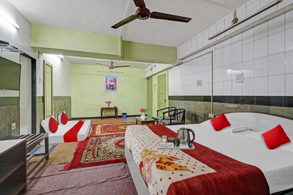 a bedroom with a large bed with red pillows at Hotel Rajdoot Near Phoenix Palladium in Mumbai