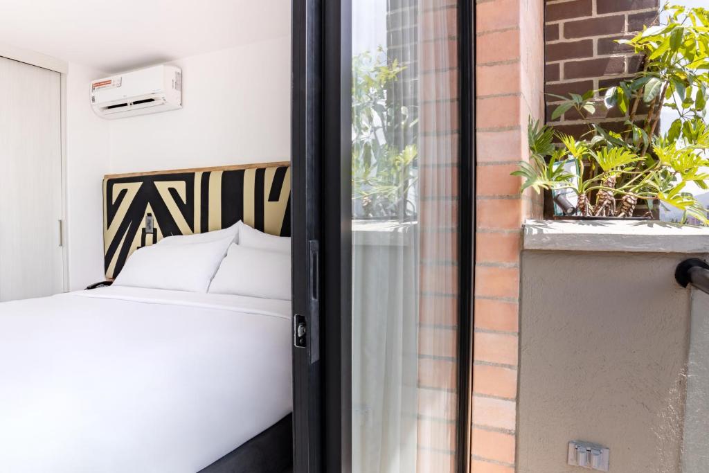 Voodi või voodid majutusasutuse Origen Local Suites toas