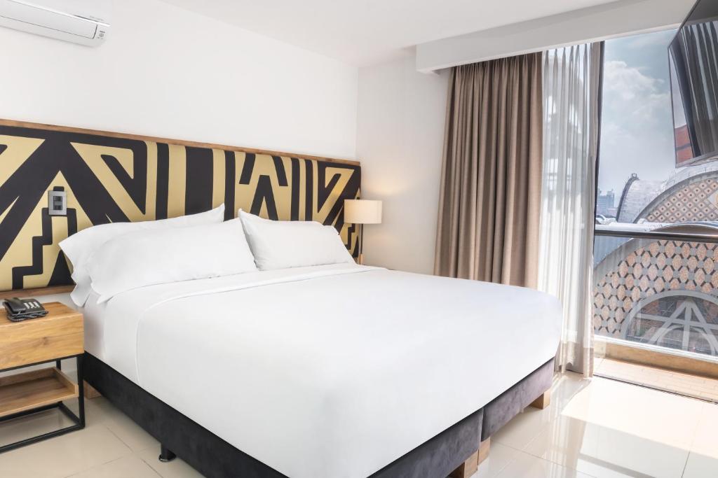 Voodi või voodid majutusasutuse Origen Local Suites toas