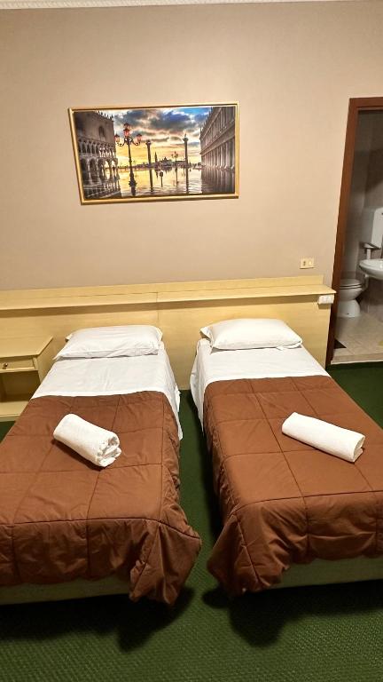 Postel nebo postele na pokoji v ubytování Nuova Locanda Belvedere
