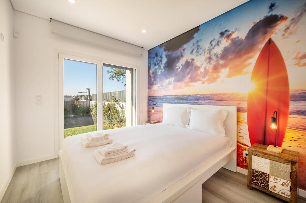 a bedroom with a surfboard mural on the wall at GuestReady - Peaceful Stay in Charneca da Caparica in Charneca
