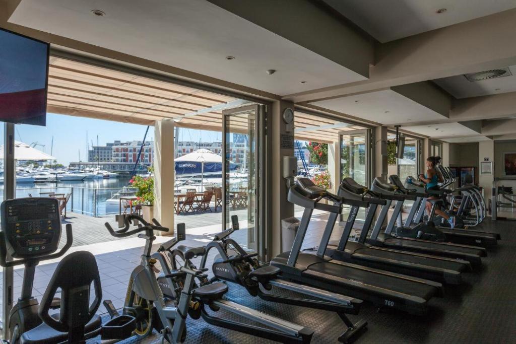 a gym with a bunch of cardio bikes in a room at Modern, beautiful 1 bed with views -V&A Waterfront in Cape Town