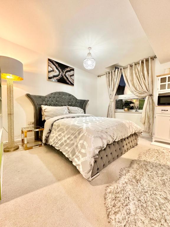 a bedroom with a large bed and a window at Luxurious & Private (Daily, weekly or monthly) in Wolverhampton