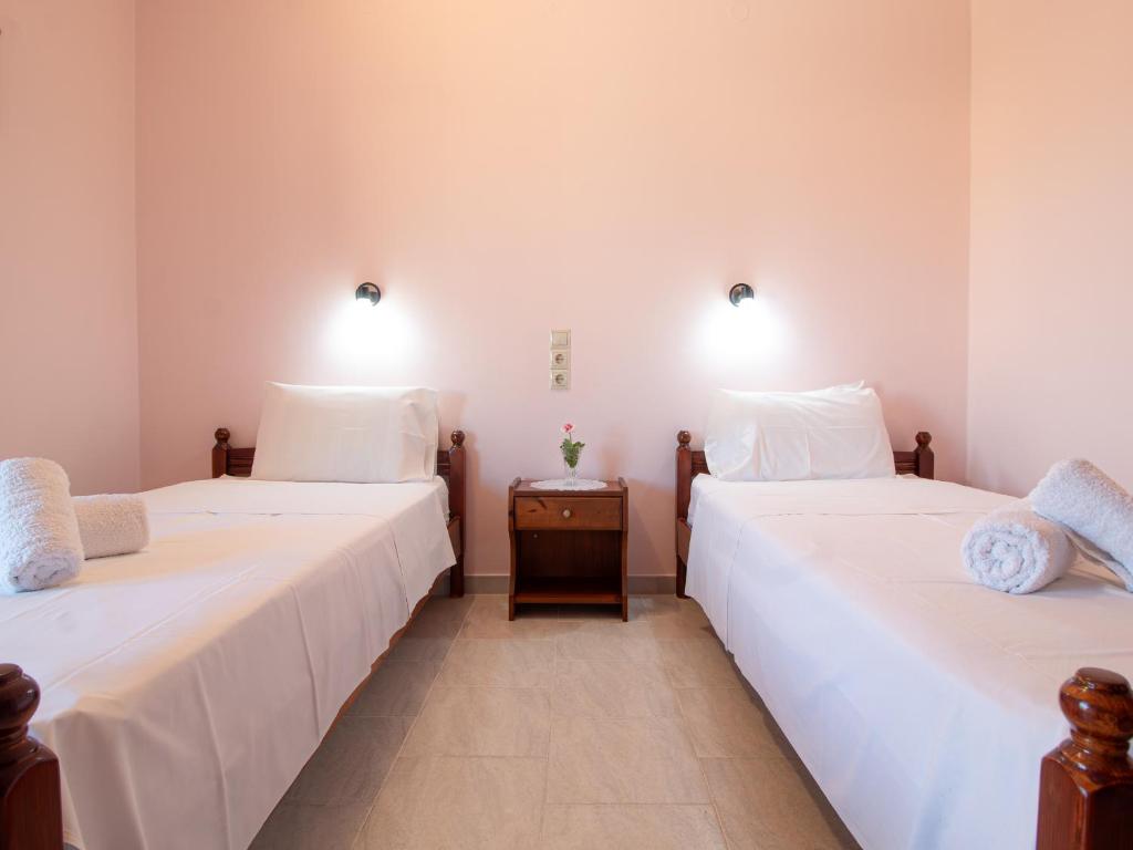 two beds sitting next to each other in a room at PORTO-FINO in Arillas