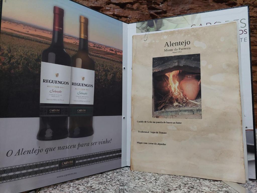 two bottles of wine are sitting next to a box at Monte da Parreira in Cabeça de Carneiro