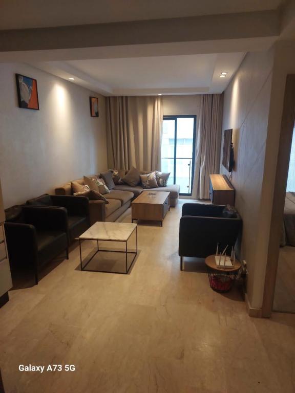 a large living room with couches and a table at One Bedroom Luxurious Suites in Casablanca