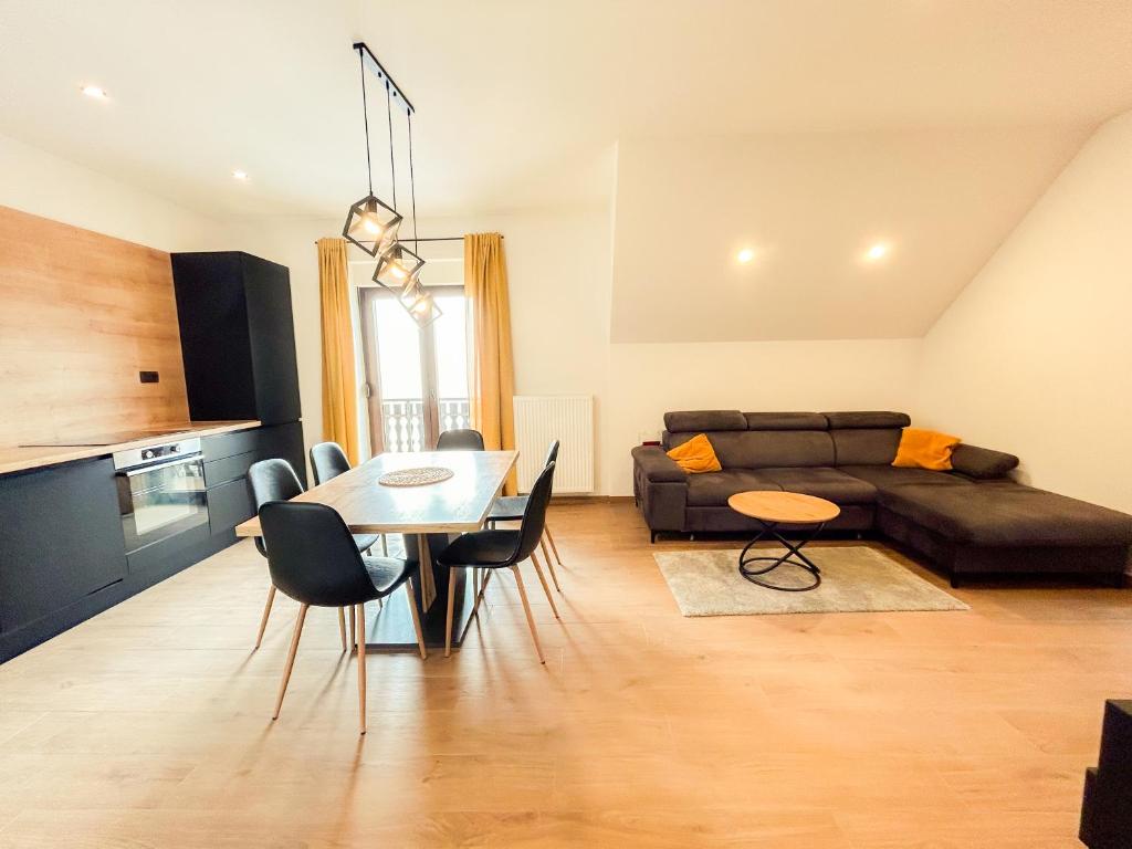 a living room with a table and a couch at Villa verde leisure apartment in Tarvisio