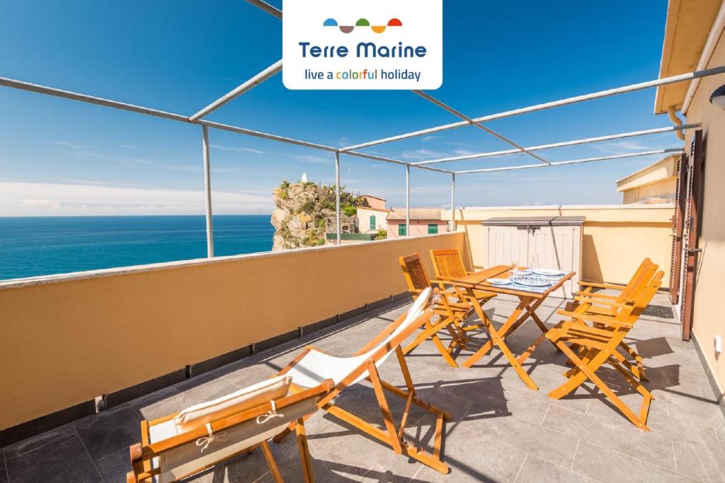 einen Balkon mit Stühlen, einem Tisch und Meerblick in der Unterkunft Queen of Sea Diamond, Terre Marine in Manarola