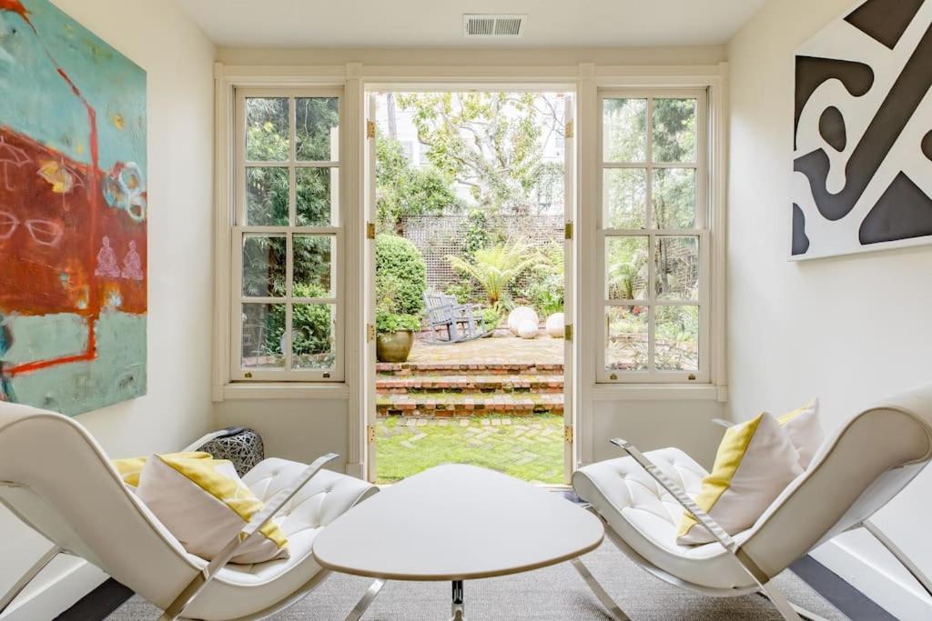 a living room with two chairs and a table at Pacific Heights Victorian Garden Suite in San Francisco