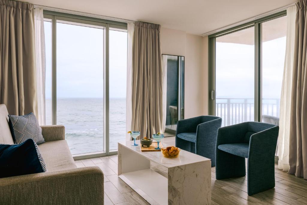 a living room with a view of the ocean at The Hillsboro powered by Sonder in Deerfield Beach