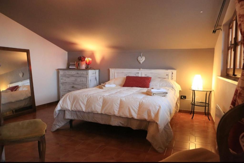1 dormitorio con 1 cama blanca grande y vestidor en Natura & Relax a Casa Trumlinot, en Sanfront