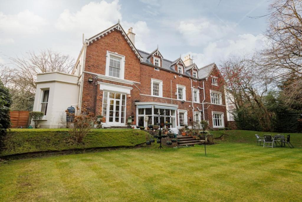 une grande maison en briques avec une pelouse devant elle dans l'établissement Eastfield, à Liverpool