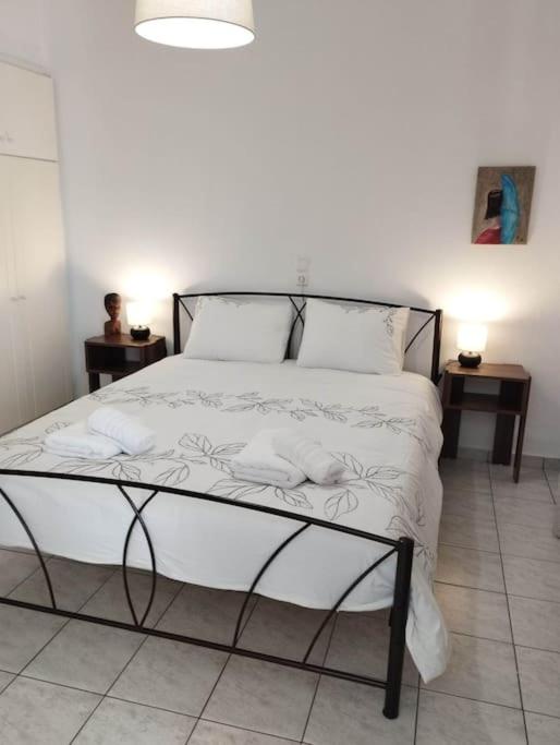 a bedroom with a bed with white sheets and pillows at Arta House in Arta