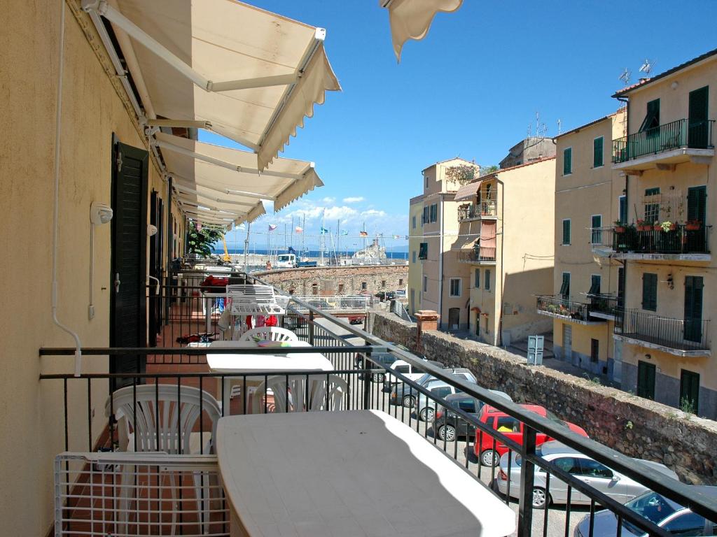 a balcony with tables and a view of a city at Al Molo in Rio Marina