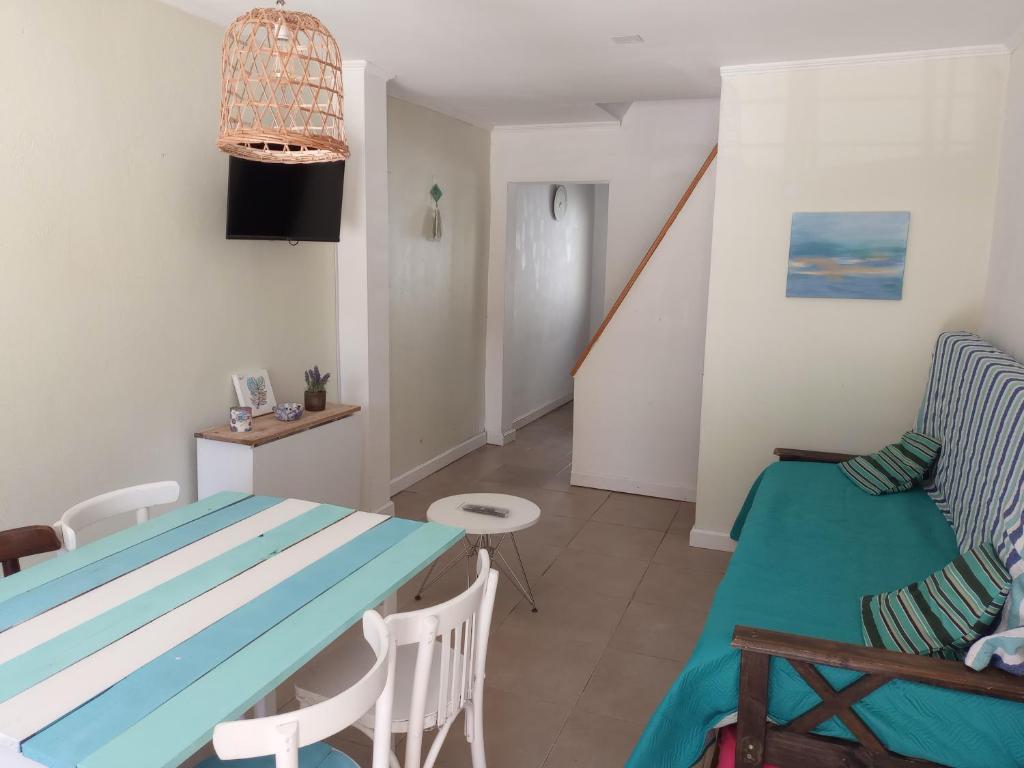 a living room with a blue table and a couch at Hermoso Duplex familiar en Zona Norte in Mar del Plata