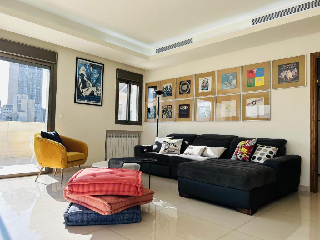 uma sala de estar com um sofá preto e uma mesa em Cloud Number 10 em Beirute