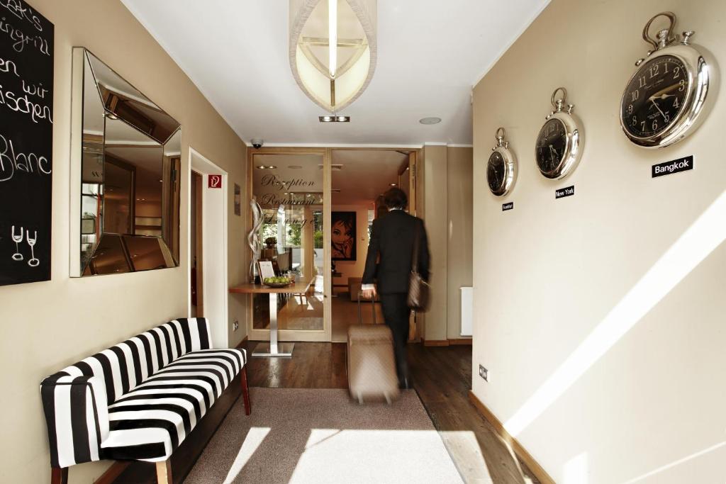 a man walking down a hallway in a store at Hotel Bonjour in Bad Soden am Taunus