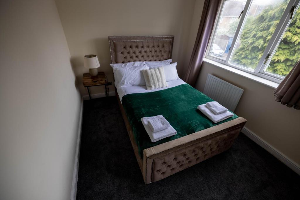 a small bed in a room with a window at Pristine Relocation 3-Bed House in London in London