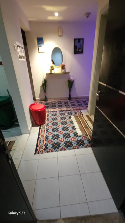 a hallway with a table and a red stool at Ruby Star Male Hostel Dubai in Dubai