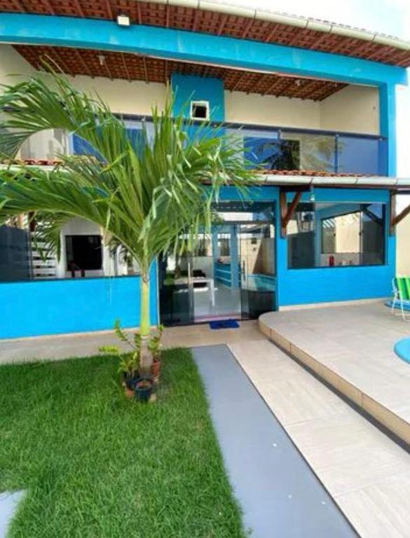 una palmera frente a una casa en summer house, en Praia Grande