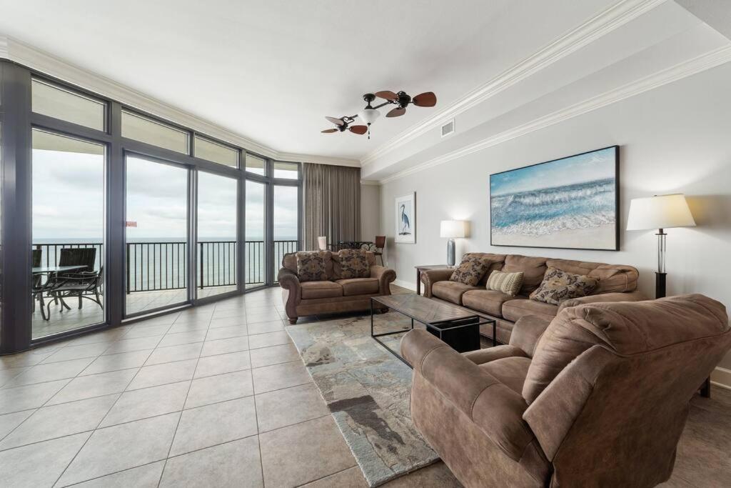 a living room with couches and a view of the ocean at The Oasis By Liquid Life in Orange Beach