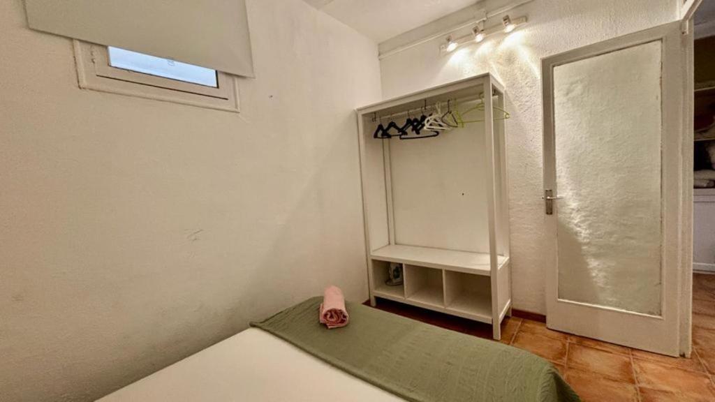 a small room with a refrigerator and a table at Cozy Ploblesec Apartment in Barcelona