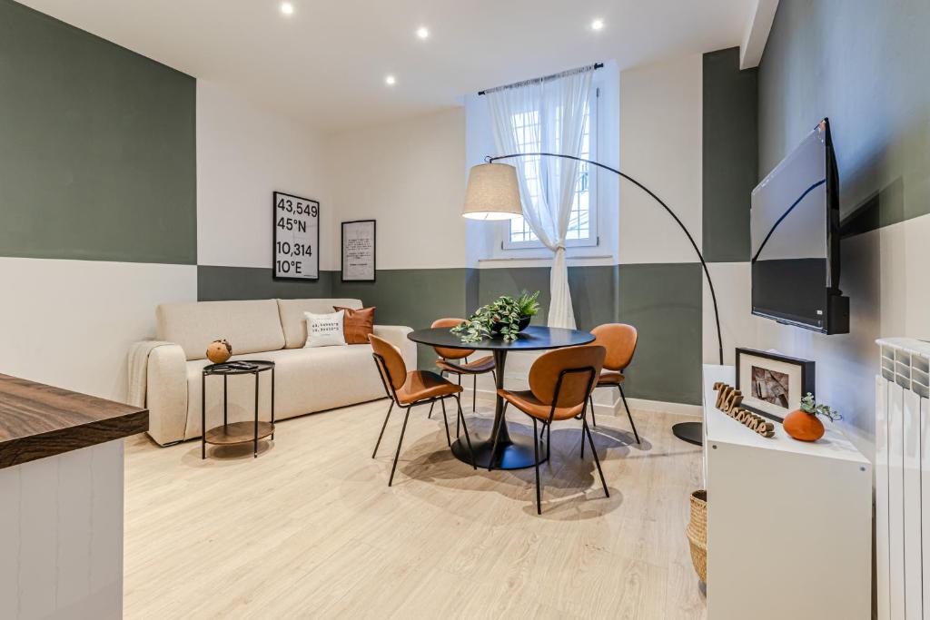 a living room with a table and a couch at Discover Apartment in Livorno