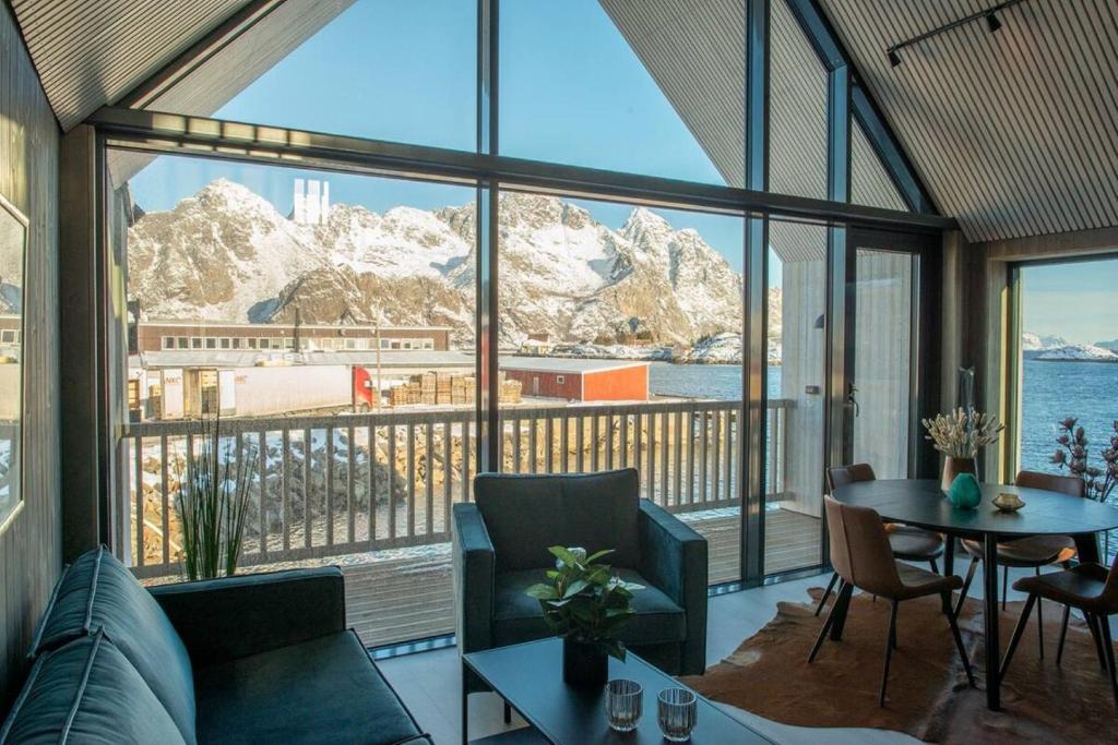 a living room with a view of the water and mountains at Ny leilighet i Henningsvær! in Henningsvær
