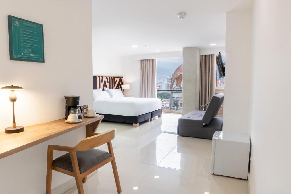 Postel nebo postele na pokoji v ubytování Origen Local Suites